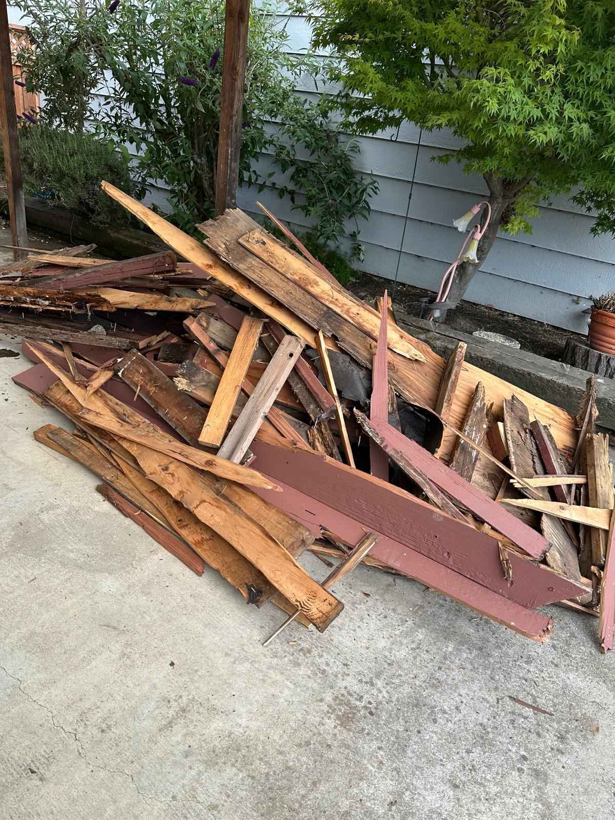 Wood planks and discarded building materials collected for removal | Divas Junk Removal Services Wood planks and discarded building materials collected for removal