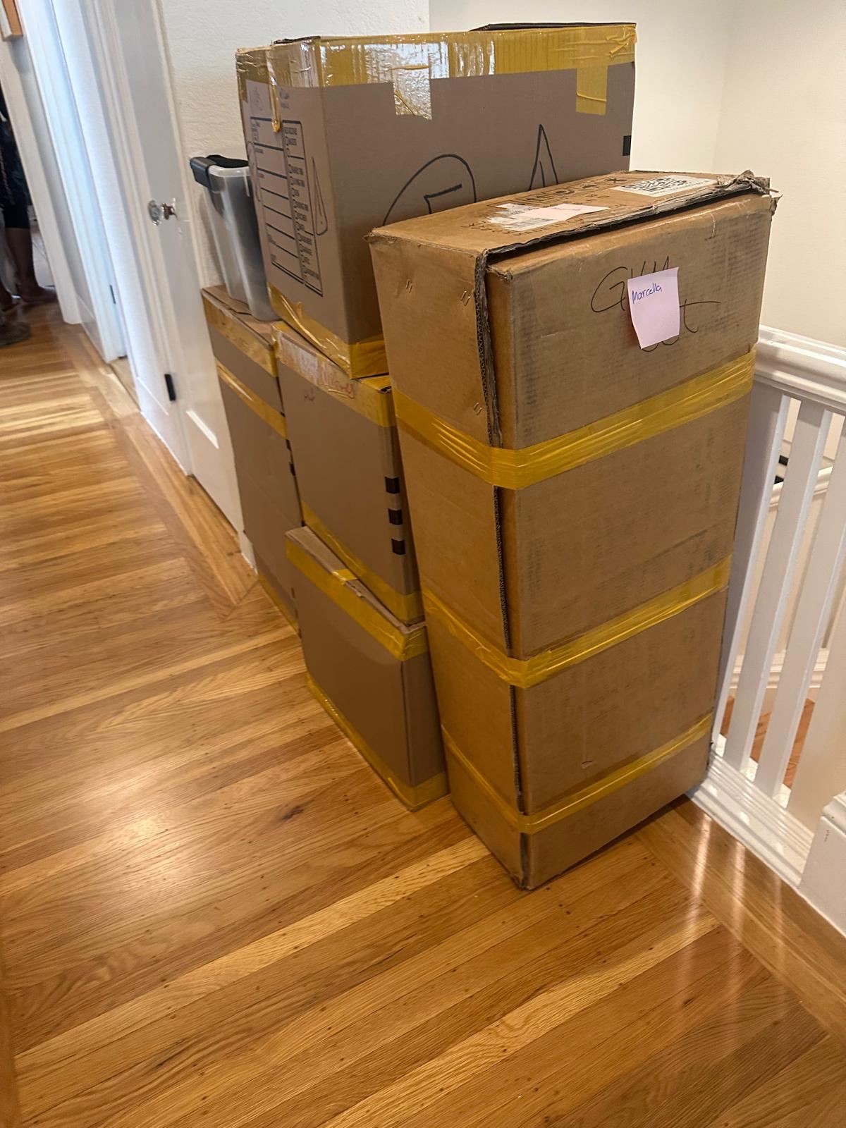 Packed boxes and household items in a residence before a move-out cleanout | Divas Junk Removal Services Packed boxes and household items in a residence before a move-out cleanout